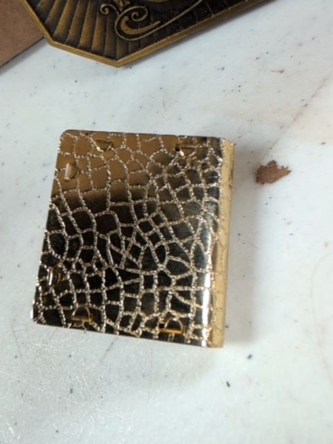 Locket book for necklace with orange gem on top