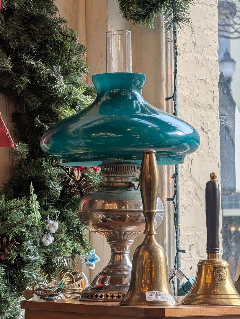 Fantastic early kerosene lamp with a wonderful green shade on it converted to electric with a turn knob on base