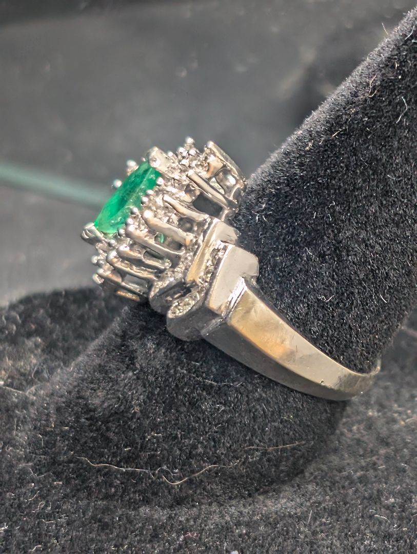 14 karat white gold ring with emerald in diamonds