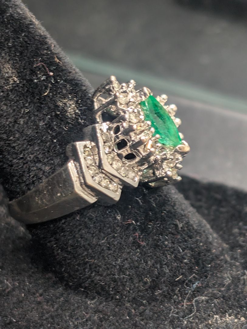 14 karat white gold ring with emerald in diamonds