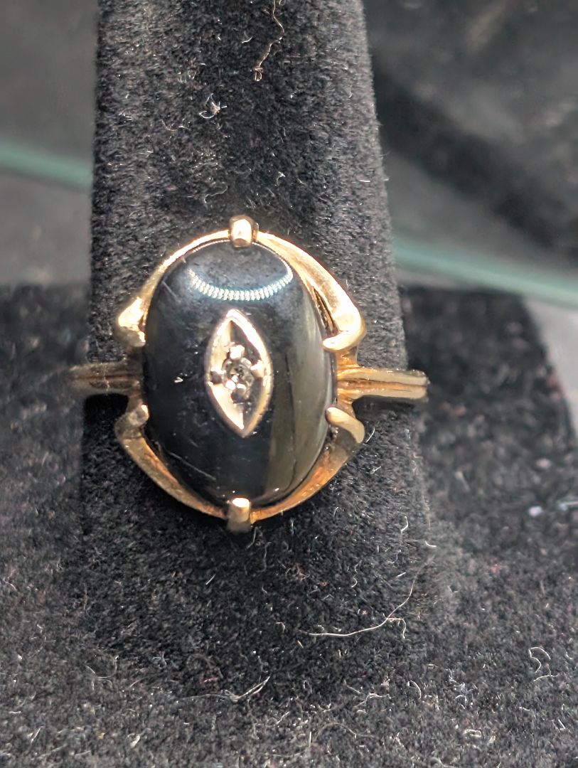 10 karat gold ring with onyx and diamond.
