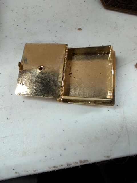 Locket book for necklace with orange gem on top